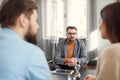 Young unhappy couple on special marriage therapy session with professional therapist. Qualified psychologist listen Royalty Free Stock Photo