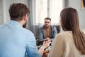 Young unhappy couple on special marriage therapy session with professional therapist. Qualified psychologist listen Royalty Free Stock Photo