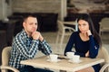 Young unhappy married couple having serious quarrel at cafe Royalty Free Stock Photo