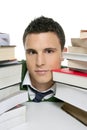 Young unhappy student with stacked books Royalty Free Stock Photo