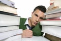 Young unhappy student with stacked books Royalty Free Stock Photo