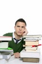 Young unhappy student with stacked books