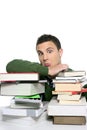 Young unhappy student with stacked books Royalty Free Stock Photo