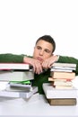 Young unhappy student with stacked books Royalty Free Stock Photo