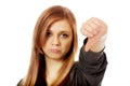 Young unhappy teenage woman showing thumb down Royalty Free Stock Photo