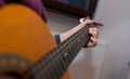 Young unidentifiable musician playing on the guitar