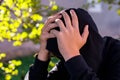 Young unidentifiable teenage boy holding hes head at the correctional institute Royalty Free Stock Photo