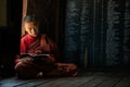 Young unidentified Buddhist monk learning in the Shwe Yan Pyay monastery school