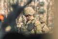 Young United States Marine Corps soldier with sunglasses, helmet and military vehicles around