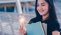 Young university student holding light bulb,creative idea Royalty Free Stock Photo