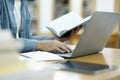Young university student using laptop for online learning, searching and learning at library. Royalty Free Stock Photo