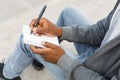 Young unrecognizable student making note Royalty Free Stock Photo