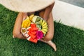 Young unrecognizable woman by the pool with a plate of tropical fruits: watermelon, pineapple, bananas, mangosteen Royalty Free Stock Photo