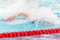 Young unrecognized man competing in freestyle swimming. Long exposure. Motion blur Royalty Free Stock Photo