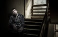 Young unsatisfied man sitting on stairs