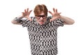 young upset angry caucasian ginger man with a tattoo on his arms is dressed in a black and white shirt wears glasses Royalty Free Stock Photo