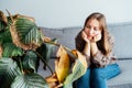 Young upset, sad woman holding dried dead foliage of her home plant Calathea. Houseplants diseases. Diseases Disorders Royalty Free Stock Photo