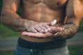 Young urban bodybuilder coating his hands with magnesium chalk for calisthenics training Royalty Free Stock Photo