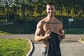 Young urban bodybuilder taking off the shirt before calisthenics training Royalty Free Stock Photo