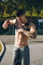 Young urban bodybuilder taking off the shirt before calisthenics training Royalty Free Stock Photo