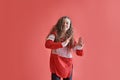 Young urban woman dancing on red background, modern slim hip-hop style teenage girl Royalty Free Stock Photo