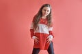 Young urban woman dancing on red background, modern slim hip-hop style teenage girl Royalty Free Stock Photo