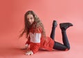 Young urban woman dancing on red background, modern slim hip-hop style teenage girl Royalty Free Stock Photo