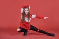 Young urban woman dancing on red background, modern slim hip-hop style teenage girl Royalty Free Stock Photo