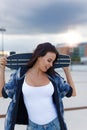 Young urban woman holding longboard behind head have fun Royalty Free Stock Photo