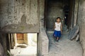 young uyghur boy in front of his home