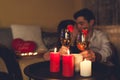 Valentines Day couple in love clinking glasses drinks wine with strawberries having romantic dinner celebrating at home Royalty Free Stock Photo