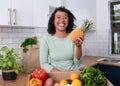 A young vegan woman holds up a pineapple with fruit and veg box delivery Royalty Free Stock Photo