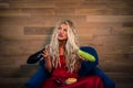 Young vegetarian woman in elegant red dress sits on armchair Royalty Free Stock Photo