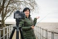 young latin traveler woman content creator outdoors making video with her camera for social media