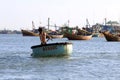 Young Vietnamese boy in coracle-like round fishing boat