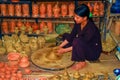 Young Vietnamese potter woman with pottery