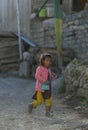 Young village girl walking in Mud village street, Spiti Valley, Himachal Pradesh, India Royalty Free Stock Photo