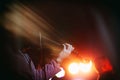 Young Violinist Girl Performance with Her Violin iNstrument on the indoor Concert Stage. Abstract Light Effects Added