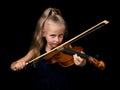 Young violinist with piercing gaze isolated on black background Royalty Free Stock Photo