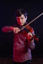 Young violinist playing. Concept of music, hobby, art, lifestyle. Musician isolated. Black background Royalty Free Stock Photo