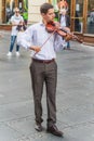 Young violinist playing on a street
