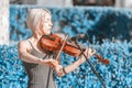 A young violinist plays under the microphone