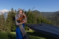 Young violinist posing against the backdrop of the Alpine mountains
