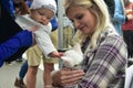 Young Visitor Interacts with Rescue Kitten from Nashville Cat Rescue at Oktoberfest Event