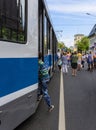 A young visitor to the exhibition of retro trams enters the old carriage of the Moscow tram of the KTM 8 series