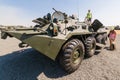 Young visitors are standing close of the Armored fighting vehicle BTR-82AM