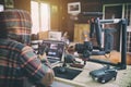 Young vlogger man editing video on laptop and checking smartphone Royalty Free Stock Photo