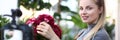 Young Vlogger Touching Red Hortensia to Camcorder