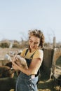 Young volunteer with a piglet, The Sanctuary at Soledad, Mojave