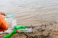 Young volunteers with garbage bags cleaning area in dirty beach of the lake, Volunteer concept. Royalty Free Stock Photo